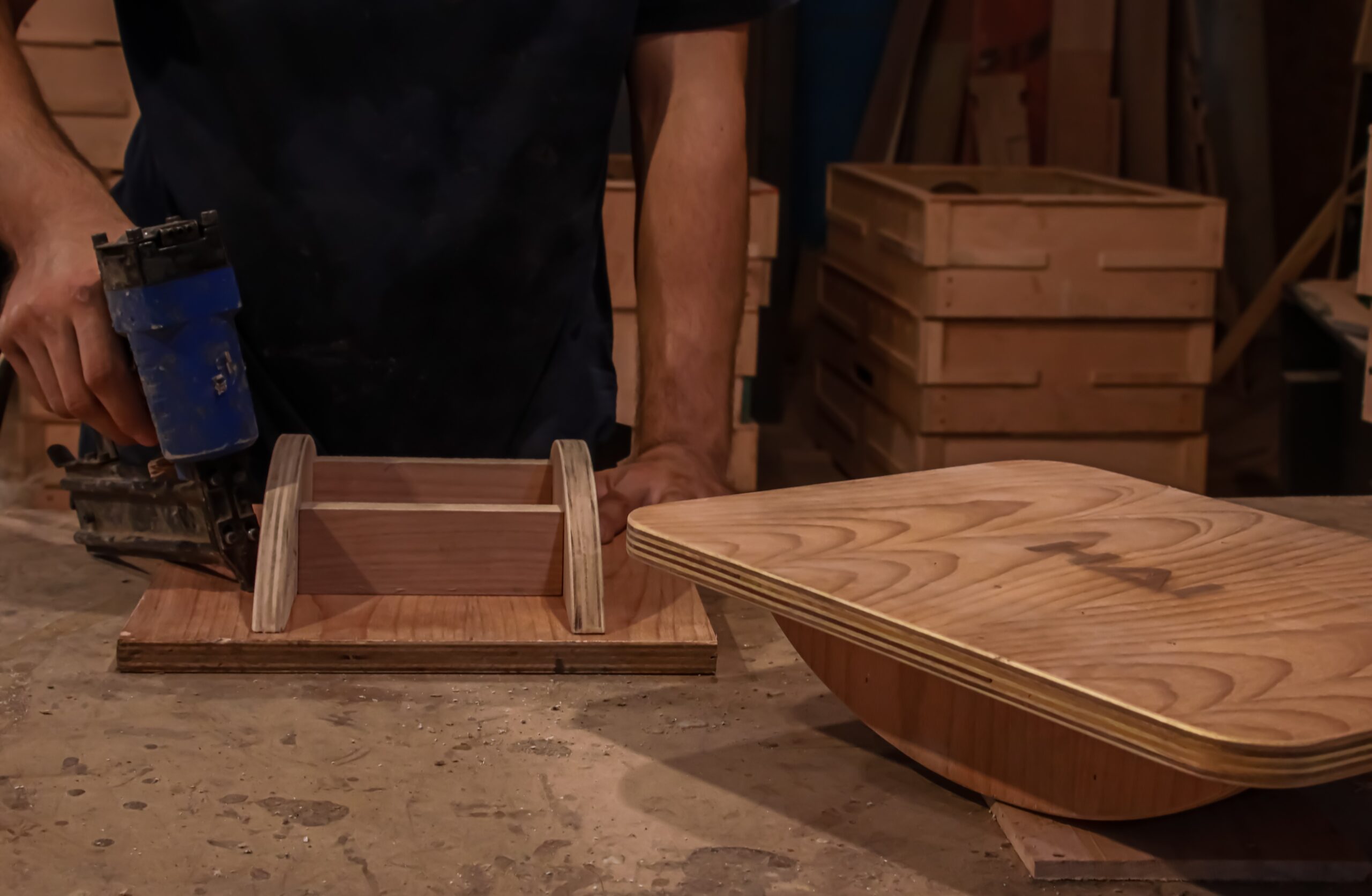 Hands assembling a wooden HAI piece in the workshop